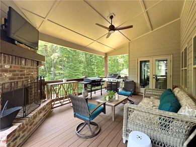 Wooden terrace with an outdoor living space with a fireplace, ceiling fan, french doors, and grilling area