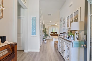 Foyer featuring light wood-style floors and a ceiling fan