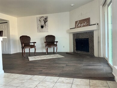 Sitting room featuring a fireplace and tile patterned floors