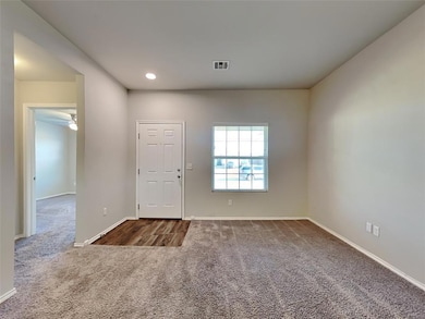 Carpeted foyer entrance featuring recessed lighting and a ceiling fan