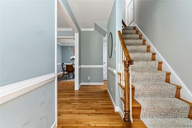 Staircase featuring light hardwood floors and orna