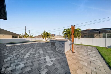 View of patio with an outdoor bar and area for gri