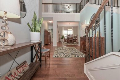 Entrance foyer with stairs, a high ceiling, wood f