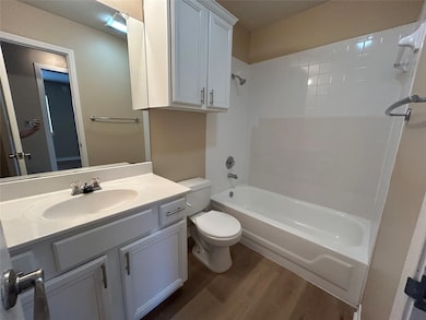 Bathroom featuring wood finished floors, bathing 