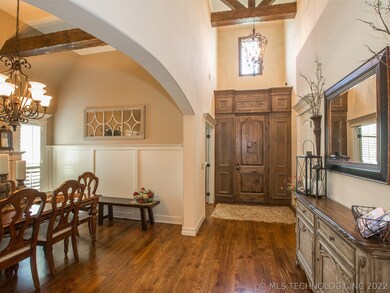Entry features tall ceiling with drop beam, hardwo