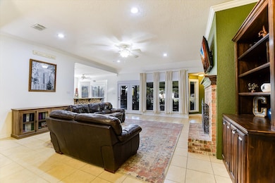 Living room with light tile patterned floors, a fireplace, recessed lighting, a textured ceiling, and a ceiling fan