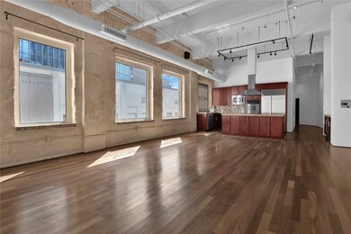 A wall of oversized windows flood living area with
