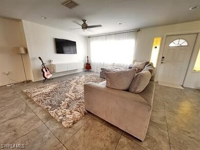 Living room with ceiling fan and a healthy amount of sunlight