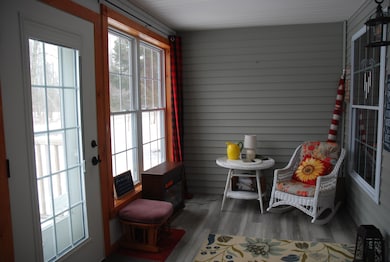 Inviting front enclosed porch...
