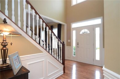 The two story entry offers gleaming hardwood floor