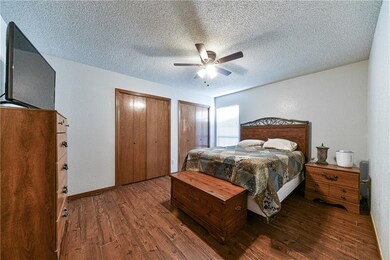 Master bedroom with wood look tile and two closets