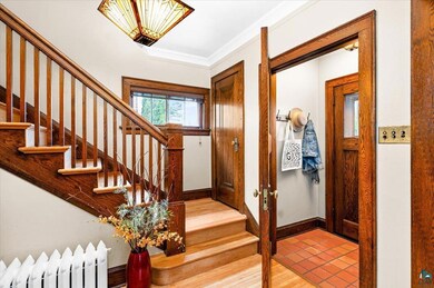 Entrance foyer featuring ornamental molding, light