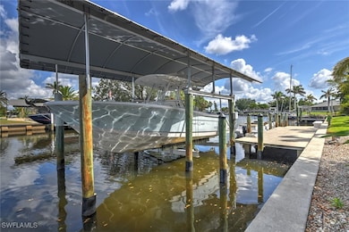Dock featuring boat lift and a water view