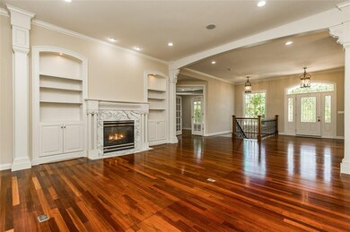 Carrera marble fireplace and custom cabinetry are 