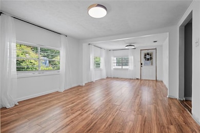 Empty room featuring wood finished floors and a textured ceiling