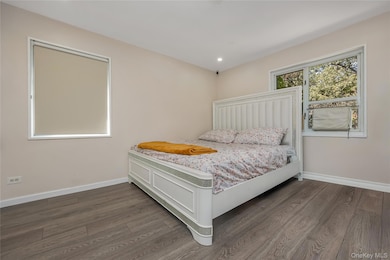 Bedroom with recessed lighting and dark wood-style floors