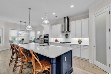 Kitchen featuring wall chimney range hood, ornamen