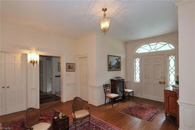 View of entry with gorgeous glass transoms around front door and large foyer area