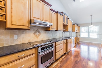 Gourmet kitchen with upgraded KraftMade real wood 