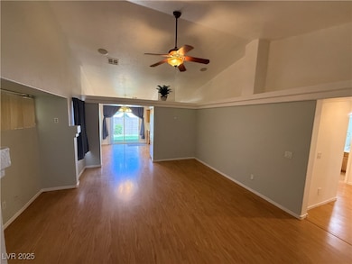 Empty room featuring a ceiling fan, wood finished