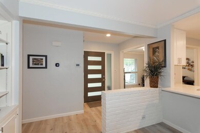 Entrance foyer with light wood-style flooring and