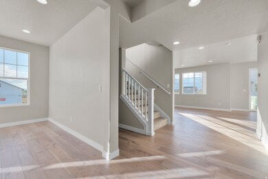 Stairs featuring hardwood / wood-style flooring, recessed lighting, and a textured ceiling