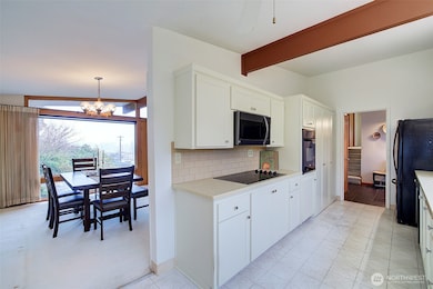 Front entry can be seen from the kitchen. The stairs go up to bedrooms and a full bath.From the kitchen nook you can see into the dining room as well.