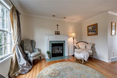 Formal living room with fireplace and hardwoods.