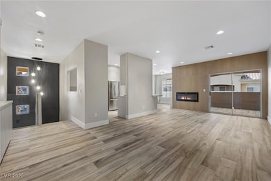 Unfurnished living room featuring light wood finis