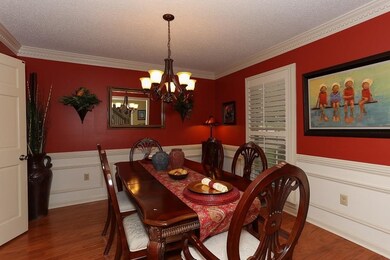 Formal dining room also has hardwood floors. Plant
