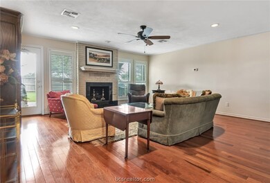 Living room with fireplace. Large windows overlook