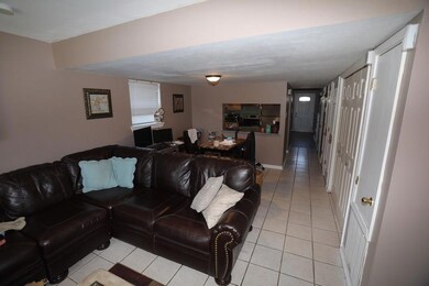 View of large den open to dining area.