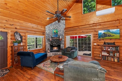 Main floor showing the stone fireplace and slider to the wrap around deck