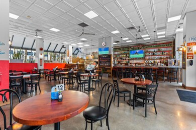 Dining area featuring concrete floors, indoor bar,