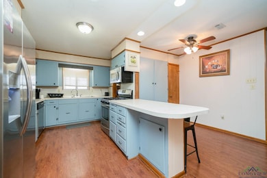 Kitchen featuring visible vents, a breakfast bar, 
