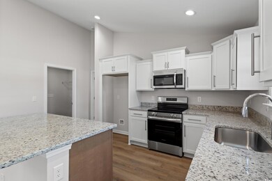 Kitchen featuring dark wood-style flooring, applia