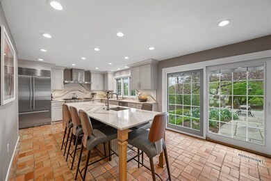 Large center island with lots of seating. Door lea