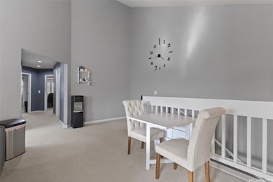 As you reach the top of the stairs, you’re welcomed by a bright and airy open-concept living space with soaring vaulted ceilings.