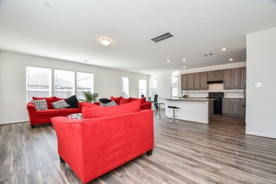 Walls of windows deliver pure natural light into this vast blended living/kitchen space.