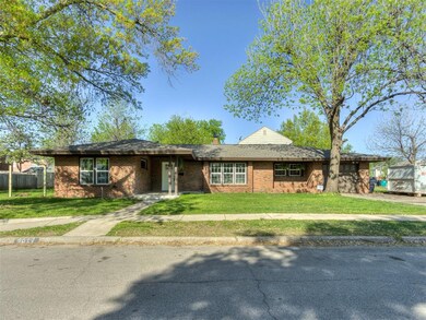 Single story home featuring brick siding, fence, a