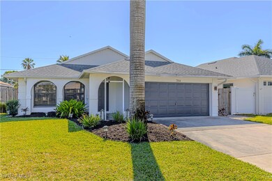 Ranch-style home with a garage and a front lawn