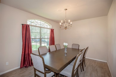 The formal dining room is filled with natural ligh