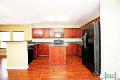 Kitchen with hardwood running throughout.