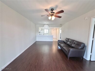 Living area with ceiling fan with notable chandeli
