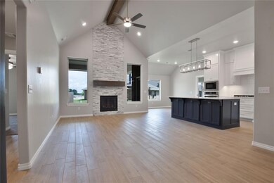 Kitchen featuring ceiling fan, beamed ceiling, a k