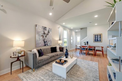 Living room featuring lofted ceiling, visible ven