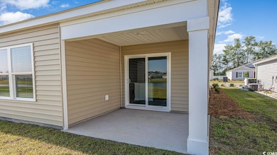 Doorway to property with a patio area