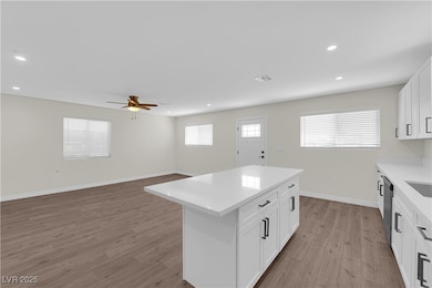 Kitchen featuring a kitchen island, light wood-typ