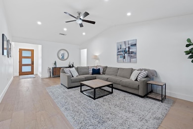 Living area featuring vaulted ceiling, wood finis