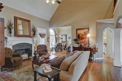 Beautiful hardwood floors, focal fireplace, soaring ceilings, open to breakfast room, dining room, kitchen and patio.